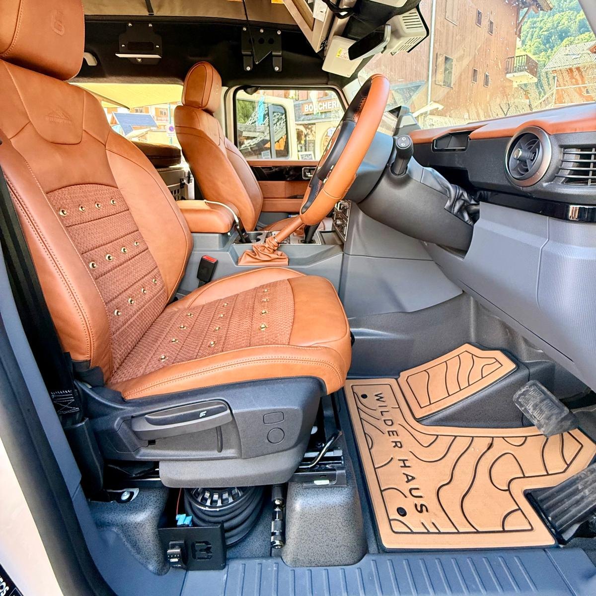 INEOS Grenadier driver's seat with the Buzz Overland onboard air compressor mount fitted underneath