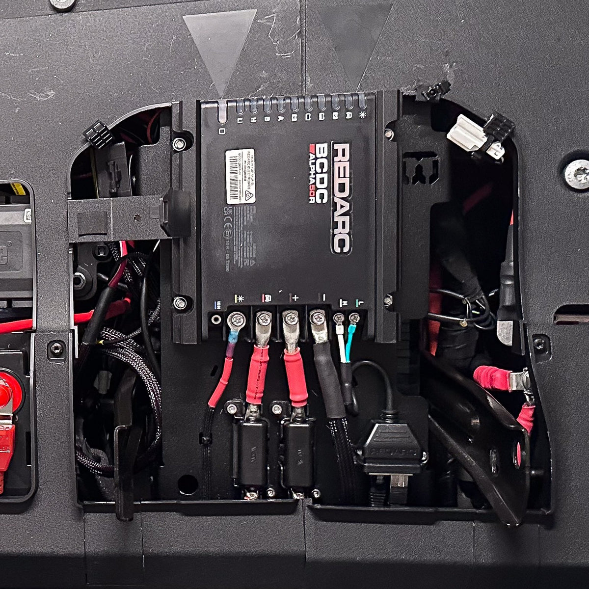 REDARC BCDC Alpha50 R wired in on the Buzz Overland under-seat bracket in an INEOS Grenadier